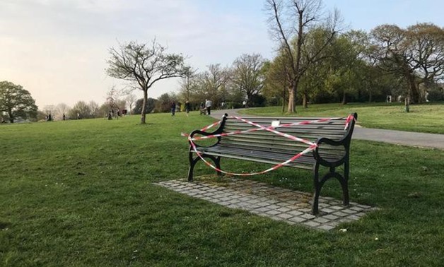 Public benches are taped off in Brockwell Park as the spread of the coronavirus disease (COVID-19) continues, London, Britain, April 8,2020. REUTERS/Reade Levinson
