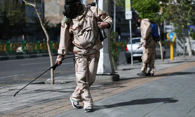 FILE PHOTO: Volunteers from Basij forces wearing protective suits and face masks spray disinfectant on the streets, amid the coronavirus disease (COVID-19) fears, in Tehran, Iran April 3, 2020. WANA (West Asia News Agency)/Ali Khara via REUTERS
