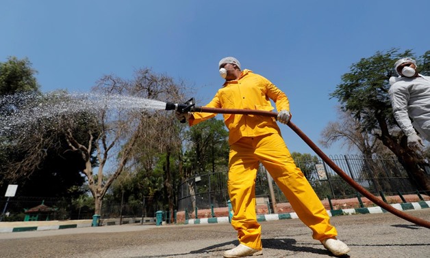 A zoo employee wearing full protective gear sprays disinfectant at the closed Giza Zoo, during the spread of coronavirus disease (COVID-19) on the outskirts of Cairo, Egypt April 8, 2020. REUTERS/Amr Abdallah Dalsh