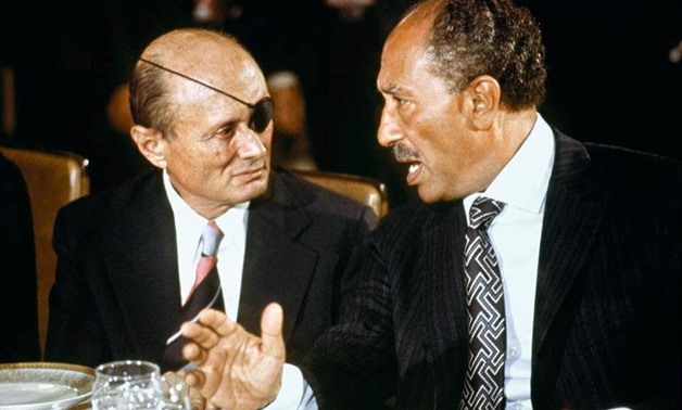Late President Anwar al-Sadat and Late Israeli Defense Minister Moshe Dayan talking while the former was visiting Jerusalem in November 1977 within peace talks rounds – Archive  