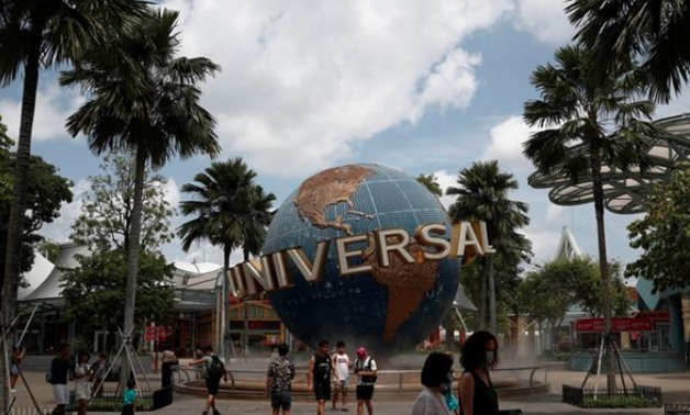 FILE PHOTO: People pose for photos at Universal Studios Singapore in Sentosa March 4, 2020. REUTERS/Edgar Su