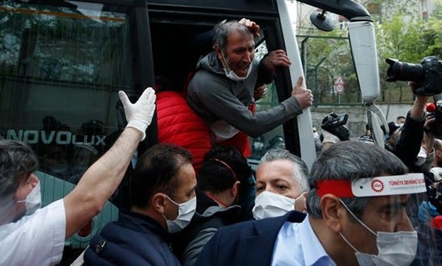 A demonstrator, wearing a face mask for protection against coronavirus, reacts after his arrest by Turkish police officers, during May Day protests in Istanbul, on May 1, 2020. (AP)
