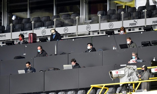 Plenty of room for a view: Journalists in the press tribune at Saturday's game between Borussia Dortmund and Schalke which was played in the absence of spectators
POOL/AFP / Martin Meissner
