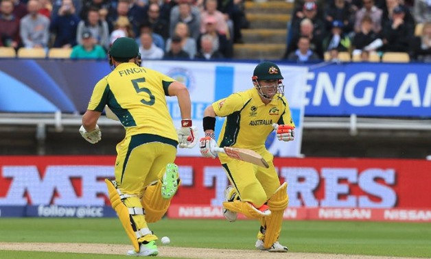 PHOTO BY AFP Australia's Aaron Finch (L) and Australia's David Warner run between the wickets during the ICC Champions Trophy