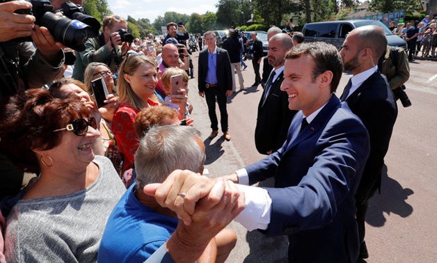 French President Emmanuel Macron leaves the polling station after voting in the first of two rounds of parliamentary elections in Le Touquet, France, June 11, 2017. REUTERS