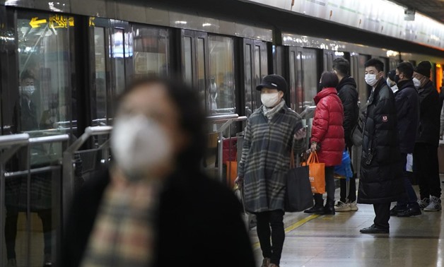 FILE PHOTO: People wearing protective masks are seen at a subway station in Shanghai, China January 23, 2020. REUTERS/Aly Song
