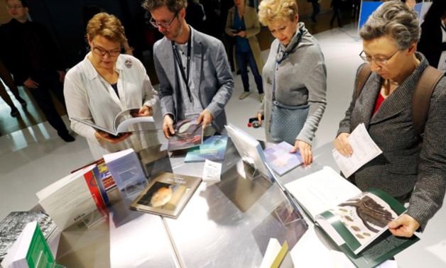 FILE PHOTO: Visitors examine books at Frankfurt book fair in Frankfurt, Germany, October 17, 2019. REUTERS/Ralph Orlowski