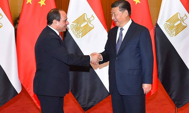 A handout picture released by the Egyptian Presidency on Saturday shows Egyptian President Abdel Fattah El-Sisi (L) shaking hands with China's President Xi Jinping upon the former's arrival in the Chinese capital Beijing. — AFP
