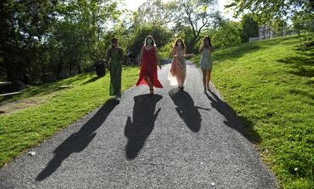 FILE PHOTO: Mila Contreras-Godfrey, Katie Reisig, Gwyn McLear and Melina Bertsekas, high school seniors graduating from Beaver Country Day School, walk through Larz Anderson Park while posing for photographs for Reuters in their prom dresses, after prom w