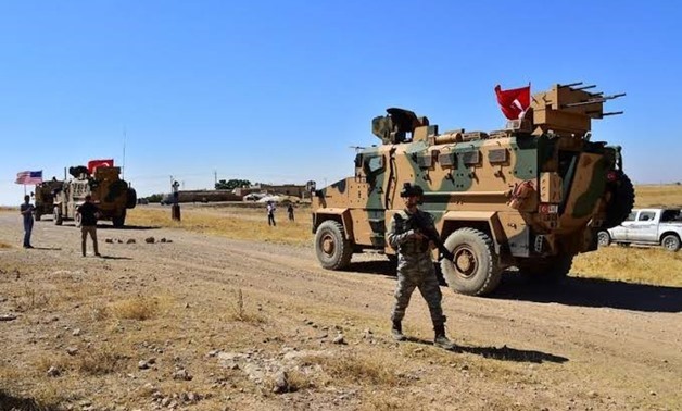 FILE PHOTO - Turkish and U.S. military vehicles are seen during a joint U.S.-Turkey patrol in a Syrian border village near Tel Abyad, Syria, September 8, 2019.Turkish Defence Ministry/Handout via REUTERS

