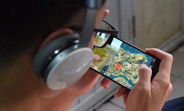 FILE - A player playing PUBG on mobile - Wikimedia Commons/Sparktour