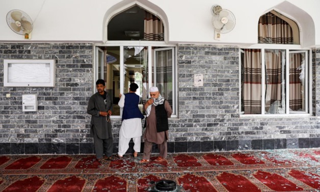 Men inspect the site of a blast inside a mosque in Kabul, Afghanistan June 12, 2020.REUTERS/Mohammad Ismail