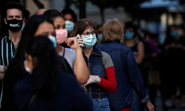 FILE PHOTO: People wearing face masks queue to enter a reopened Primark store as Madrid eases lockdown restrictions following the coronavirus disease (COVID-19) outbreak, in Madrid, Spain, June 11, 2020. REUTERS/Susana Vera/
