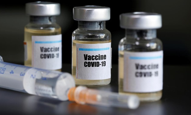 FILE PHOTO: Small bottles labeled with a "Vaccine COVID-19" sticker and a medical syringe are seen in this illustration taken April 10, 2020. REUTERS/Dado Ruvic/Illustration/File Photo