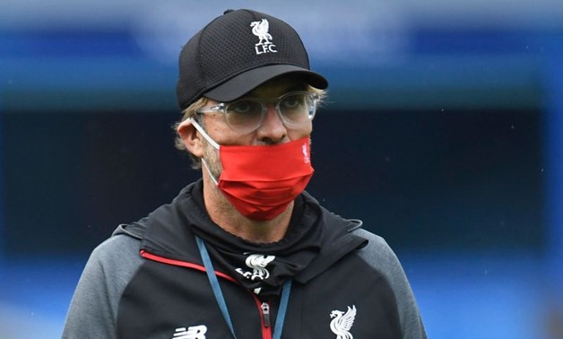 FILE PHOTO: Soccer Football - Premier League - Everton v Liverpool - Goodison Park, Liverpool, Britain - June 21, 2020 Liverpool manager Juergen Klopp wearing a mask on the pitch before the match, as play resumes behind closed doors following the outbreak