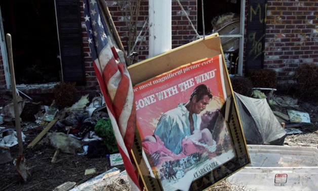 FILE PHOTO: A movie poster for "Gone with the Wind" sits in a front yard of a home damaged by Hurricane Katrina in Chalmette, Louisiana, in St. Bernard Parish September 28, 2005. REUTERS/Lee Celano/File Photo