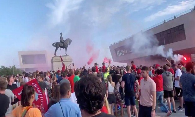 Soccer fans gather at Liverpool's Pier Head, during the novel coronavirus pandemic, celebrating Liverpool FC winning the Premier League title, in Britain June 26, 2020 in this still image taken from social media video. Content filmed June 26, 2020. Paul K