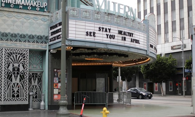 FILE PHOTO: A theater displays a closed sign during the global outbreak of coronavirus (COVID-19) in Los Angeles, California, U.S., March 16, 2020. REUTERS/Lucy Nicholson/File Photo.