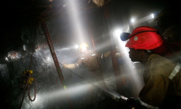 Mine workers employed at Sibanye Gold's Masimthembe shaft operate a drill in Westonaria, South Africa, April 3, 2017. Picture taken April 3, 2017. REUTERS