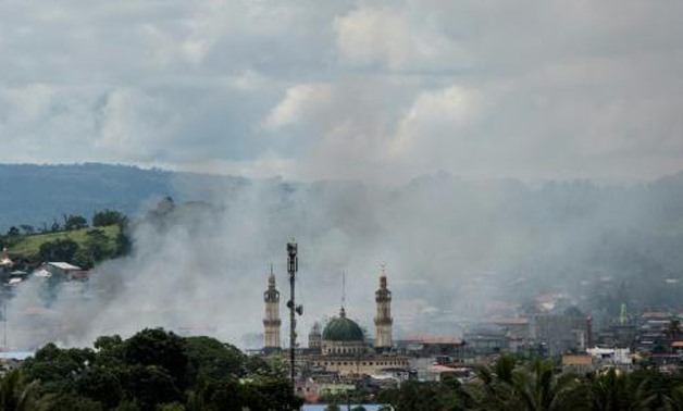 Philippine troops raise flag as bombs fall on Islamist-held city - AFP