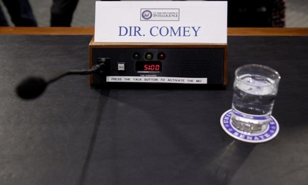 A microphone and glass of water stand ready for FBI Director James Comey before a Senate Intelligence Committee hearing - REUTERS/Joshua Roberts