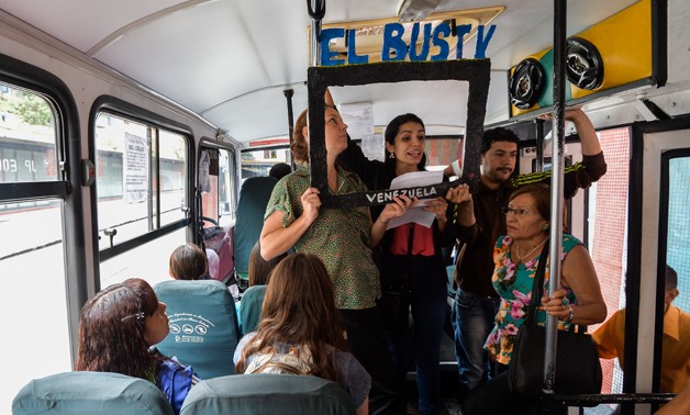 Laura Castillo (L), Maria Gabriela Fernandez (C) and Dereck Blanco (R) give a presentation of the Bus TV news in Caracas, Venezuela, on June 6, 2017- AFP
