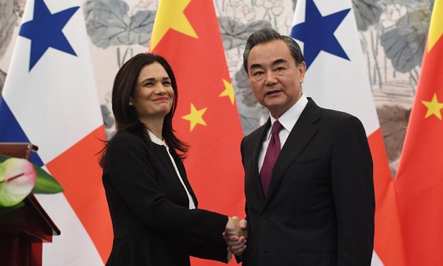 Panama's Vice President and Foreign Minister Isabel Saint Malo shakes hands with Chinese Foreign Minister Wang Yi after the two signed - AFP/GREG BAKER