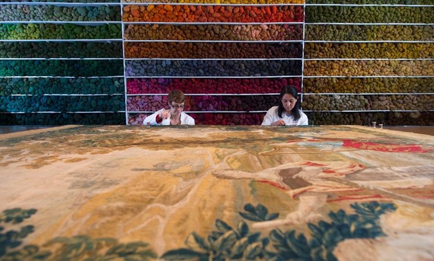 Specialists work at the Royal Manufacturers De Wit in Belgium currently the world's biggest restorer of old tapestries - AFP
