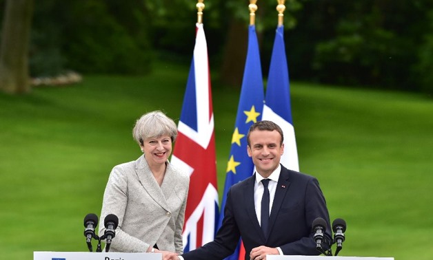Britain's Prime Minister Theresa May (L) and France's President Emmanuel Macron meet at The Elysee Palace in Paris on June 13, 2017 (AFP Photo/CHRISTOPHE ARCHAMBAULT)
