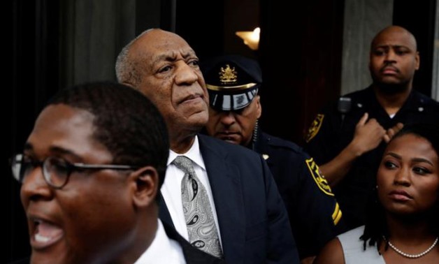 Actor and comedian Bill Cosby (2nd L) stands as his publicist, Andrew Wyatt, addresses the media after a judge declared a mistrial in Cosby's - REUTERS/Lucas Jackson