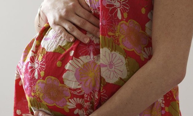 A woman holds her stomach at the last stages of her pregnancy in Bordeaux April 28, 2010. REUTERS/Regis Duvignau