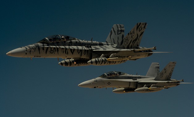 Two U.S. Marine Corps F-18 Super Hornets depart after receiving fuel - File Photo/Air Force/Staff Sgt. Michael Battles via REUTERS 