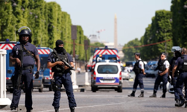 French policemen secure the area on the Champs Elysees avenue after an incident in Paris, France, June 19, 2017. REUTERS/Gonzalo Fuentes.