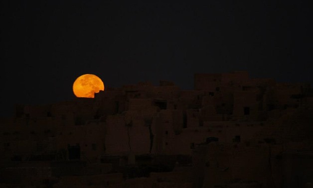 Moon sets at Shaly, Siwa Oasis – Nancy Ragab