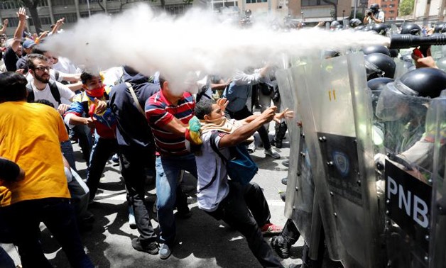 Opposition demonstrators march towards OAS headquarters in Caracas after the OAS General Assembly rules out issuing a resolution on the crisis in Venezuela
