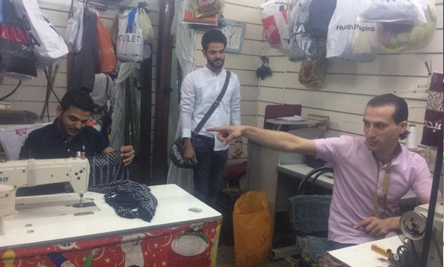 Kamel Hassan (L) at his shop in Grand Mall of Maadi- Egypt Today