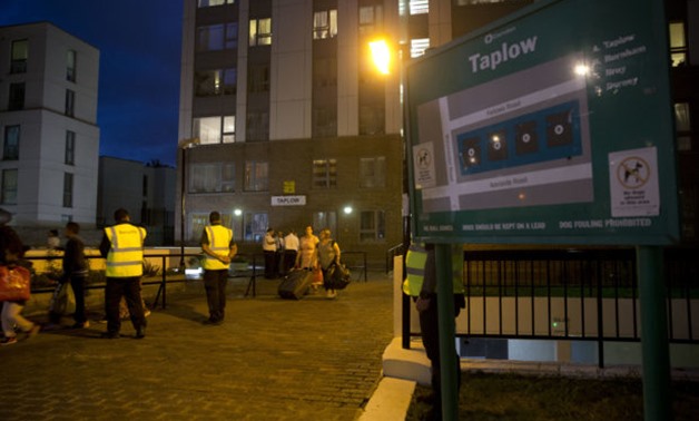 Residents are evacuated from the Taplow residential tower block on the Chalcots Estate, in the borough of Camden, north London, Friday, June 23, 2017. A local London council has decided to evacuate some 800 households in apartment buildings it owns becaus