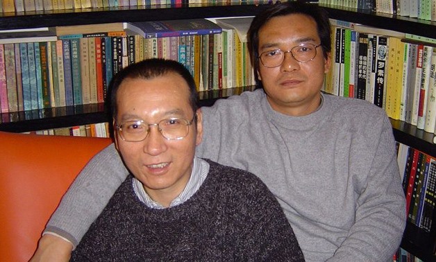 This handout picture released by the family of Liu Xiaobo taken on March 14, 2005 shows 2010 Nobel peace laureate Liu Xiaobo (L) and his brother Liu Xiaoxuan- AFP