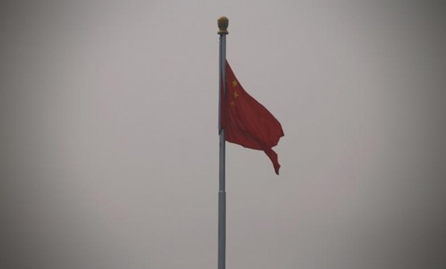 A Chinese national flag flutters at Tiananmen Square in Beijing October 20, 2014. REUTERS/Petar Kujundzic