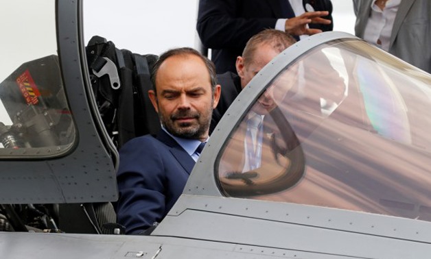 French Prime Minister Edouard Philippe sits in the cockpit of Dassault Rafale fighter as he visits the 52nd Paris Air Show at Le Bourget Airport near Paris, France June 23, 2017. Photo: Reuters