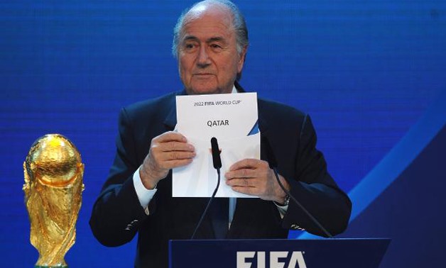Then FIFA President Joseph S Blatter names Qatar as the winning hosts for 2022 - AFP