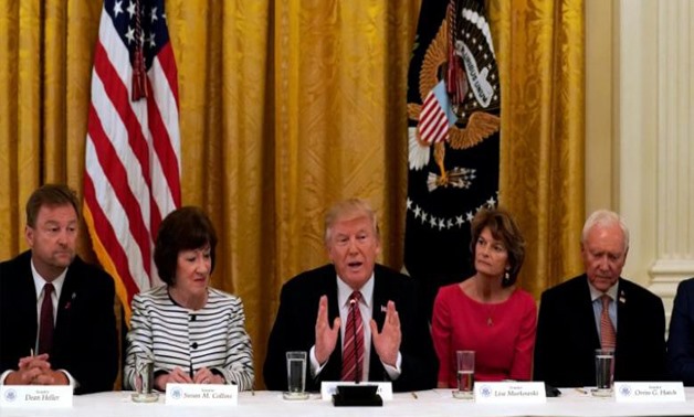 U.S. President Donald Trump meets with Senate Republicans about healthcare in the East Room of the White House in Washington, U.S., June 27, 2017. Trump is flanked by Senators Susan Collins (R-ME) and Sen. Lisa Murkowski (R-AK). REUTERS/Kevin Lamarque