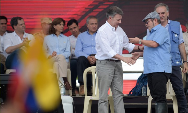 The Farc rebel leader, Rodrigo Londono, and the Colombian president, Juan Manuel Santos, attend the final act of disarmament in Mesetas. Photograph: Raul Arboleda/AFP/Getty Images