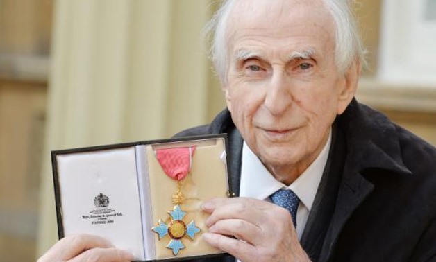 Michael Bond, creator of Paddington Bear, holding his Commander of the Order of the British Empire (CBE) after it was presented to him by Prince William at an Investiture ceremony at Buckingham Palace in central London, October 27, 2015 -
 REUTERS/John S