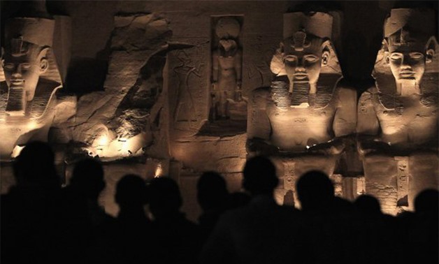 Tourists look at the Abu Simbel temple during a daily sound and light show, on the eve of the anniversary of Pharaoh Ramses - Reuters 