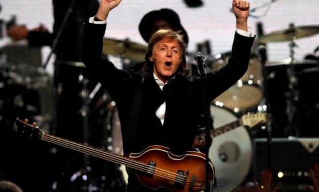 FILE PHOTO:  Paul McCartney celebrates after performing with Ringo Starr (not pictured) during the 2015 Rock and Roll Hall of Fame Induction Ceremony in Cleveland, U.S. on Ohio April 18, 2015. REUTERS/Aaron Josefczyk/File Photo
FILE PHOTO: Paul McCartney