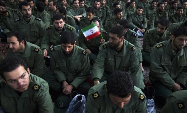Members of the revolutionary guard attend the anniversary ceremony of Iran's Islamic Revolution at the Khomeini shrine in the Behesht Zahra cemetery, south of Tehran, February 1, 2012 - REUTERS