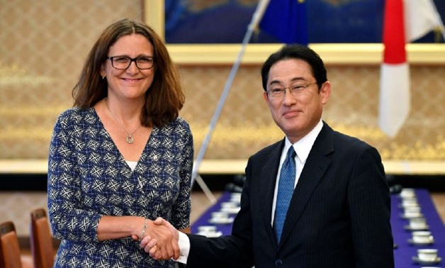 European Commissioner for Trade Cecilia Malmstrom (left) shakes hands with Japanese Foreign Minister Fumio Kishida before the start of their meeting as a part of the Japan-EU Economic Partnership Agreement negotiations at Iikura guest house in Tokyo 30 Ju