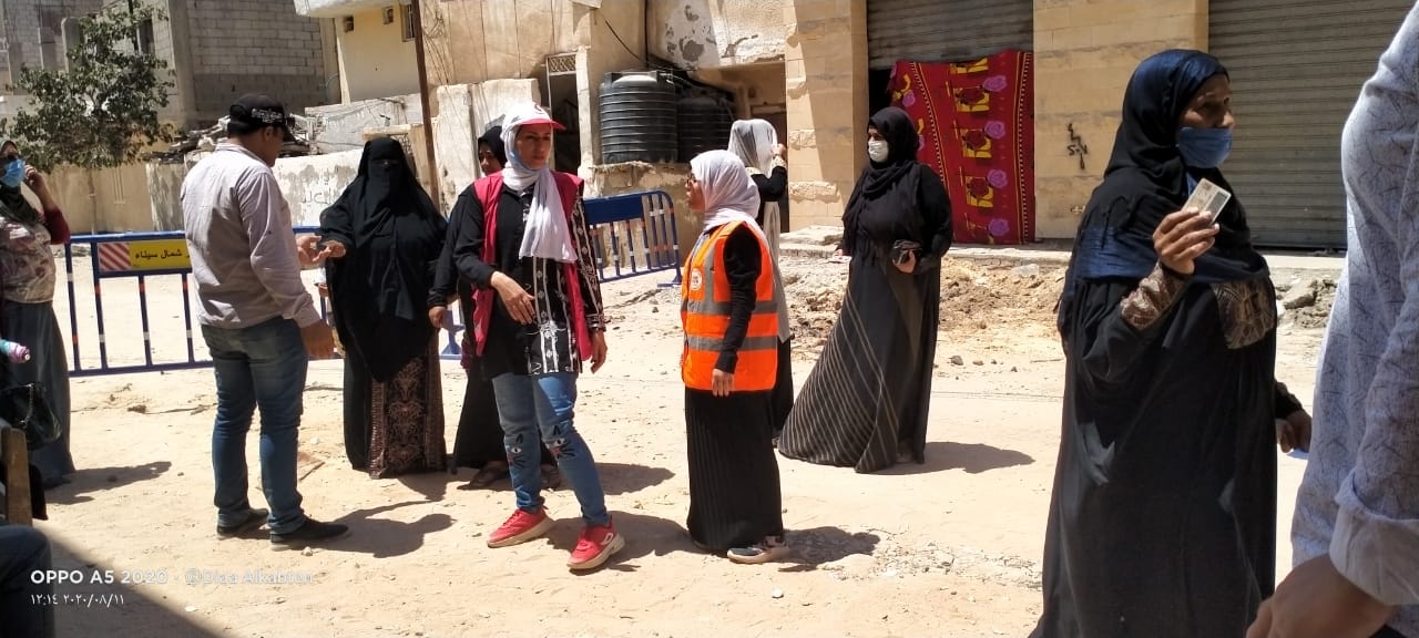 Girls in Arish, North Sinai, volunteered to help voters outside polling stations.