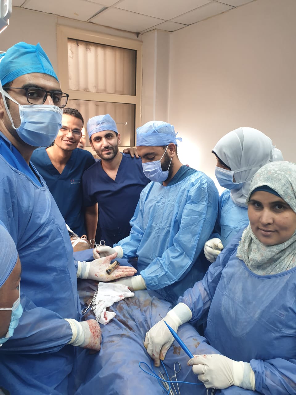 Medical team during a surgery to extract a mobile phone from a man